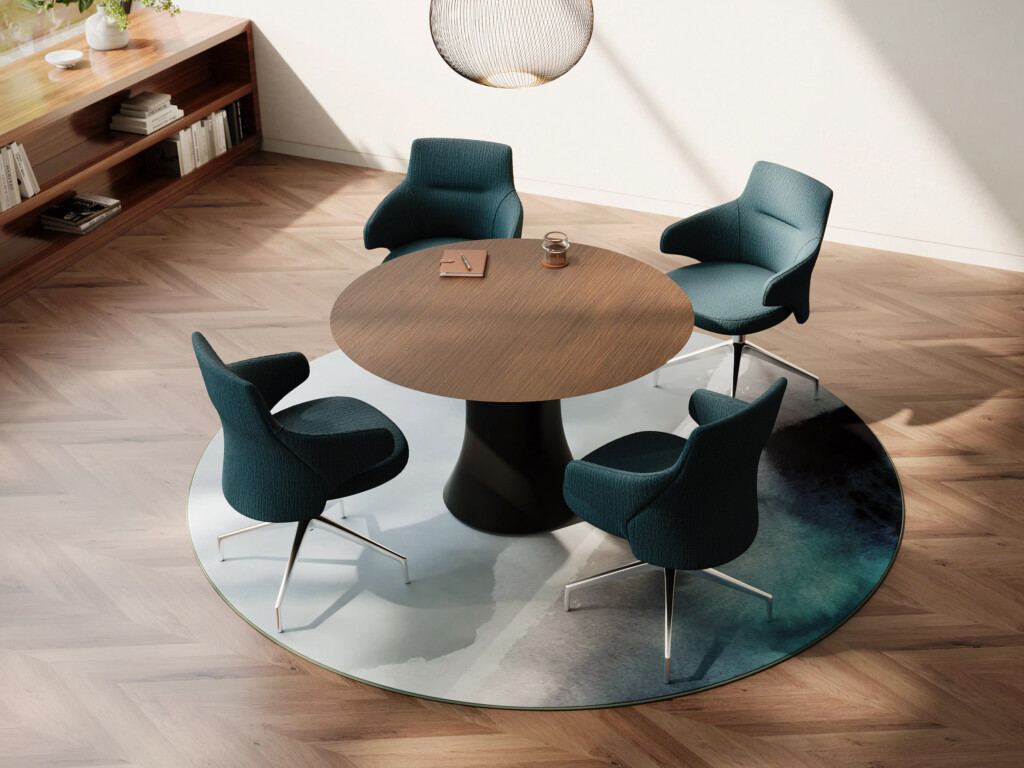 Modern meeting area with round wood table and four upholstered chairs