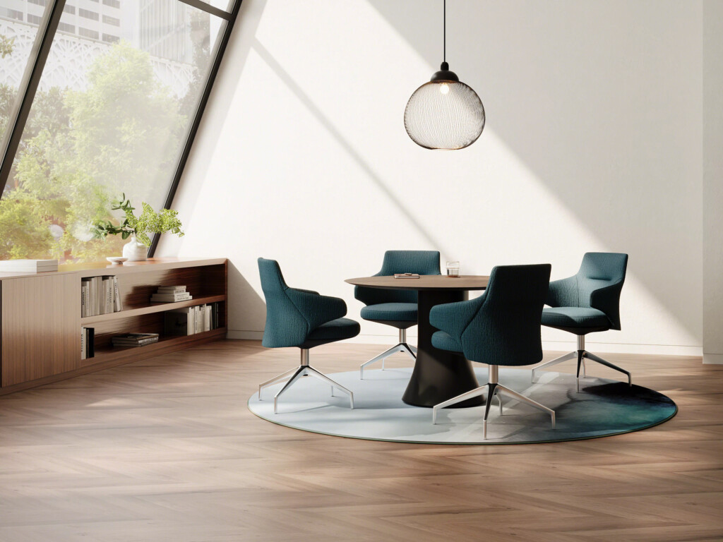 Modern meeting area with round wood table and four upholstered chairs