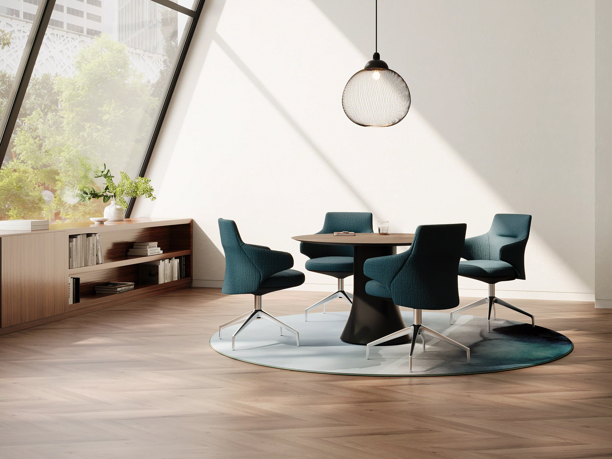 Modern meeting area with round wood table and four upholstered chairs