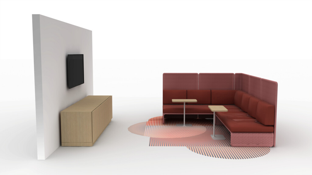 Modern lounge booth with red upholstered seating, side tables, wall-mounted screen, and storage cabinet