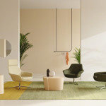 Bob Lounge Chair in a modern office setting, featuring a single-seat lounge chair with flared arms and a matte polished aluminum base, placed on a neutral-toned rug with a side table and decorative items.