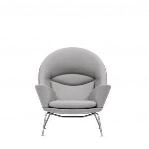 Round backed office lounge chair with high armrests, grey upholstery, aluminum legs, and a design stitched into the back