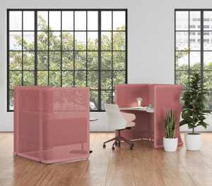 Two pink office privacy nooks around lounge chair and office desk with potted plants and glass window nearby
