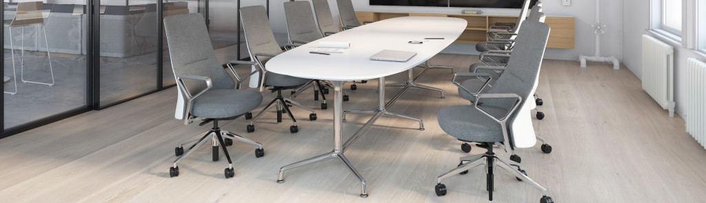 White oval conference table surrounded by high back grey conference chairs