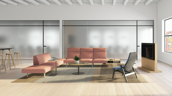 Office lounge area with bench seating, lounge chairs, monitor wall, and glass window walls