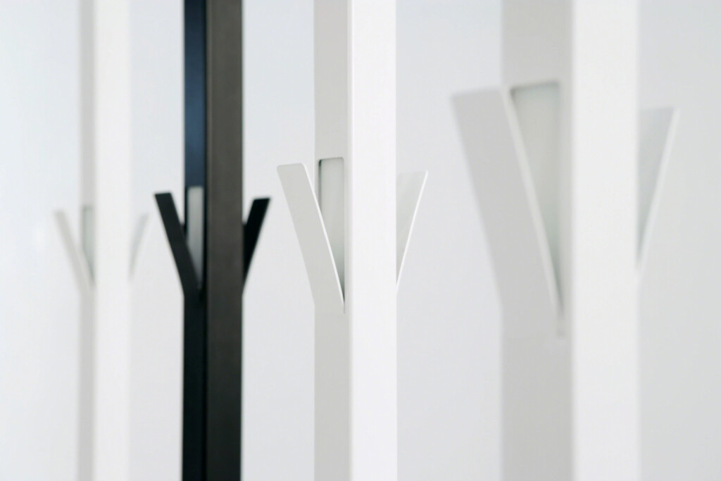 A black Viccarbe rack in line with other white racks.