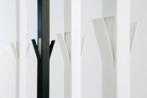A black Viccarbe rack in line with other white racks.