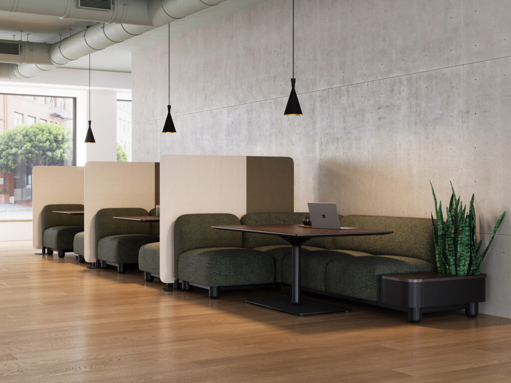 Private booth seating with upholstered benches, wood tables, and pendant lighting in modern workspace