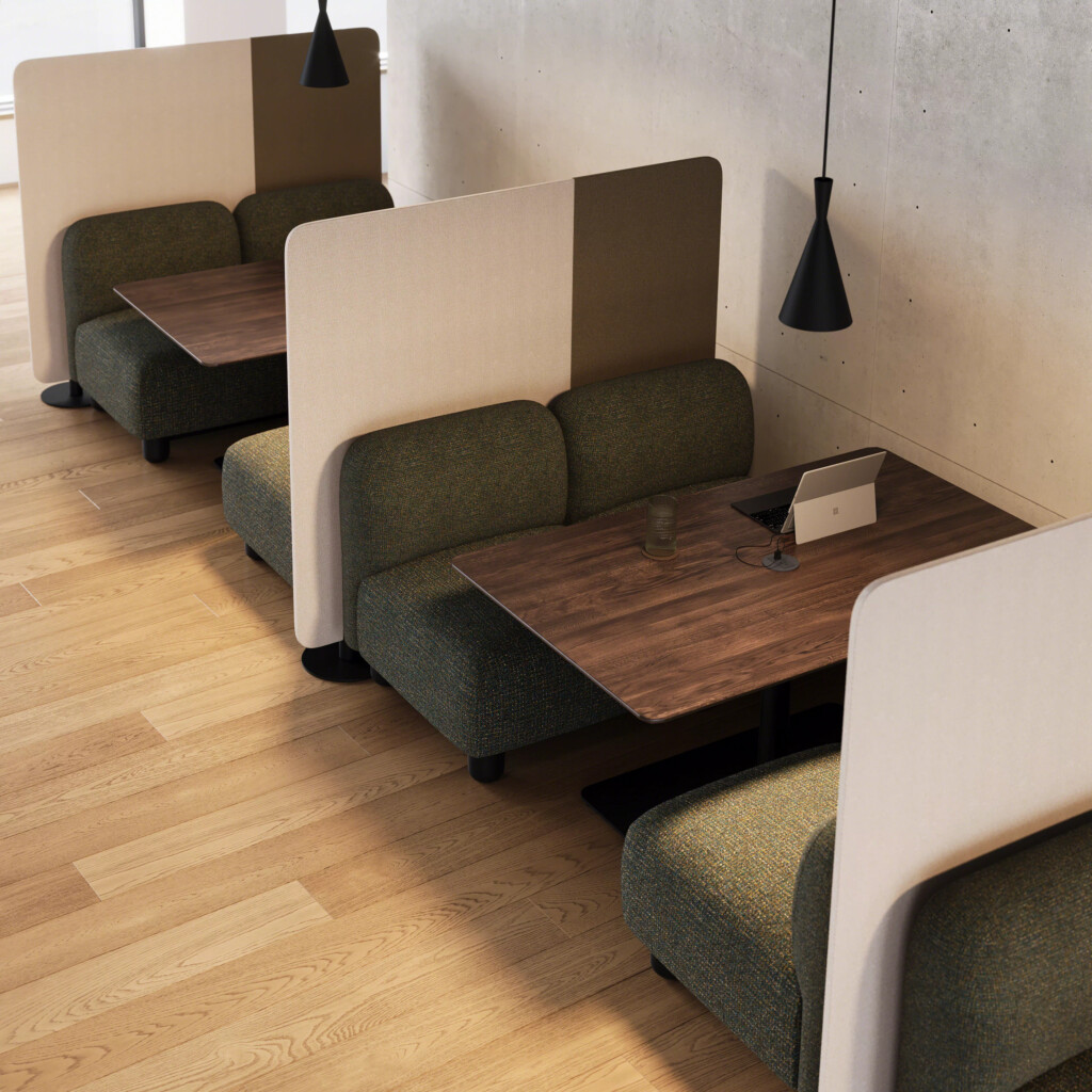 Private booth seating with upholstered benches, wood tables, and pendant lighting in modern workspace