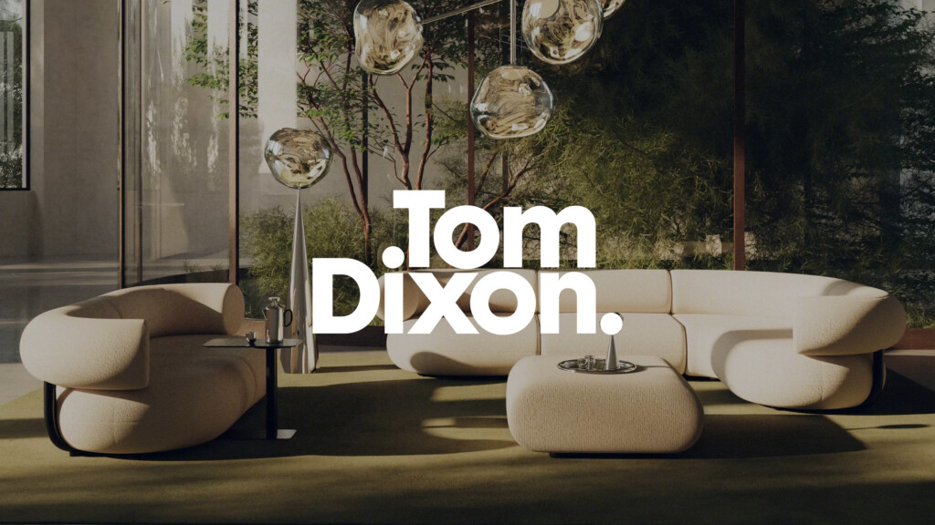 Modern lounge setting with sculptural seating, glass pendant lights, and greenery for partner Tom Dixon.