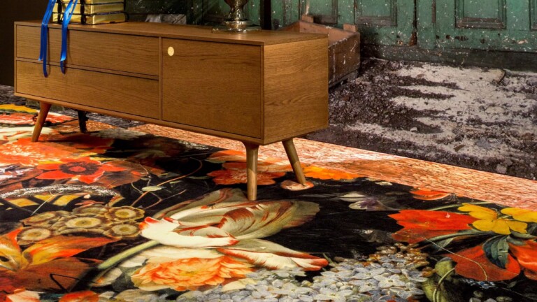 Wooden sideboard with tapered legs placed on a patterned floral rug