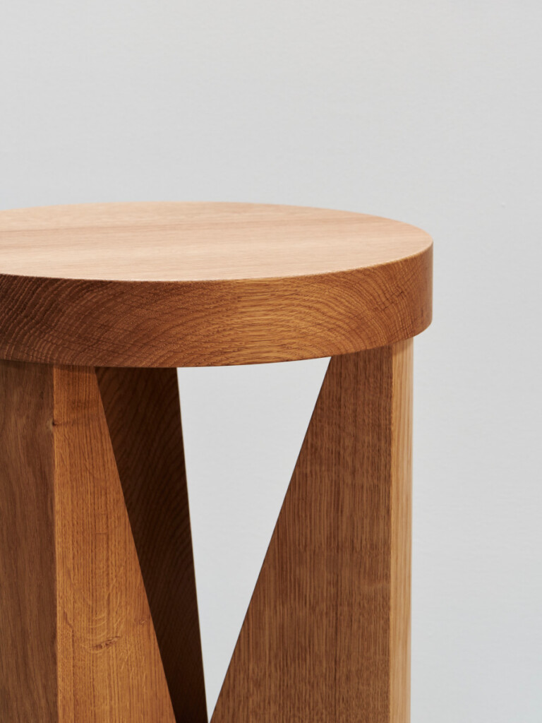 Close up view Cugino wooden stool on neutral background.