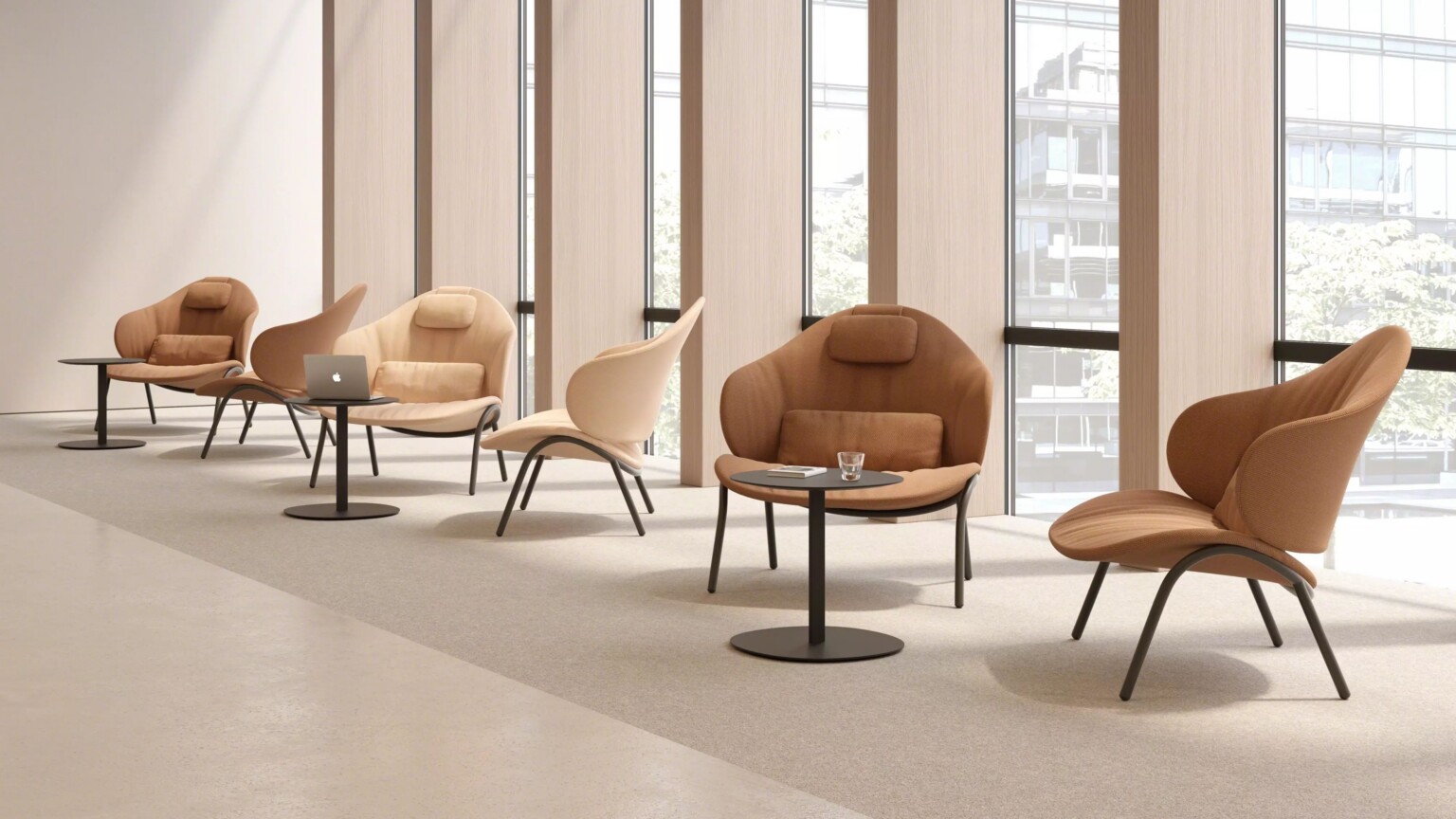 Row of lounge chairs with small round tables in a modern office setting