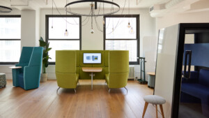 Modern collaborative workspace with privacy seating, meeting pods, and lounge furniture