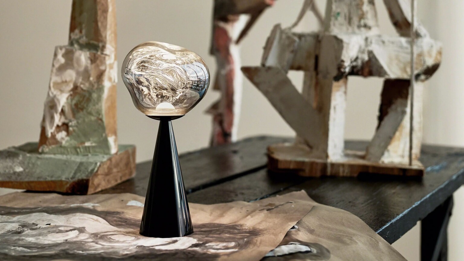 Decorative table lamp with a glass globe shade on a dark surface