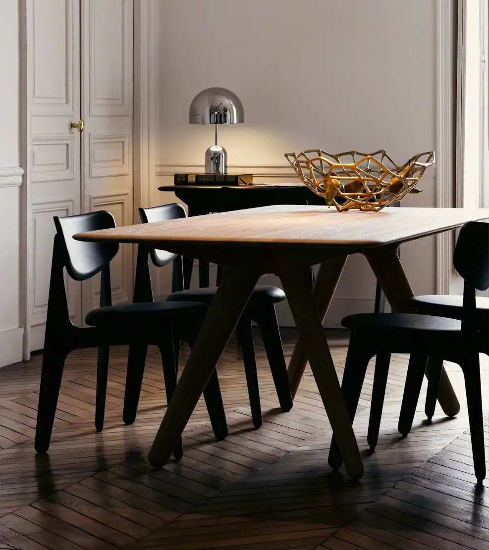 Dining room with a wooden table, black chairs, and decorative objects