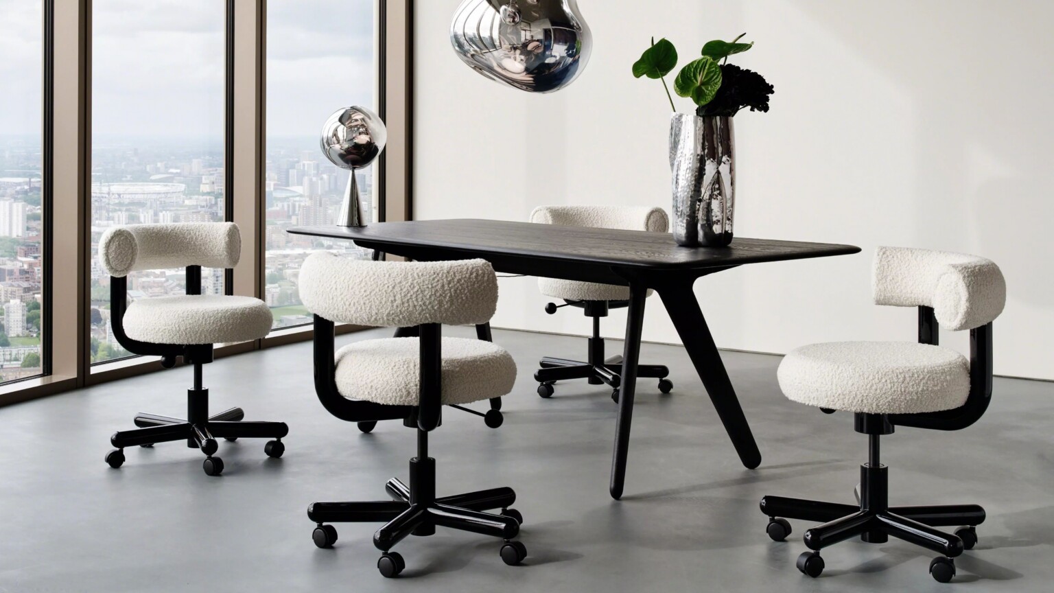 Modern setup with a black table, white chairs and metallic lamps with white background and large windows