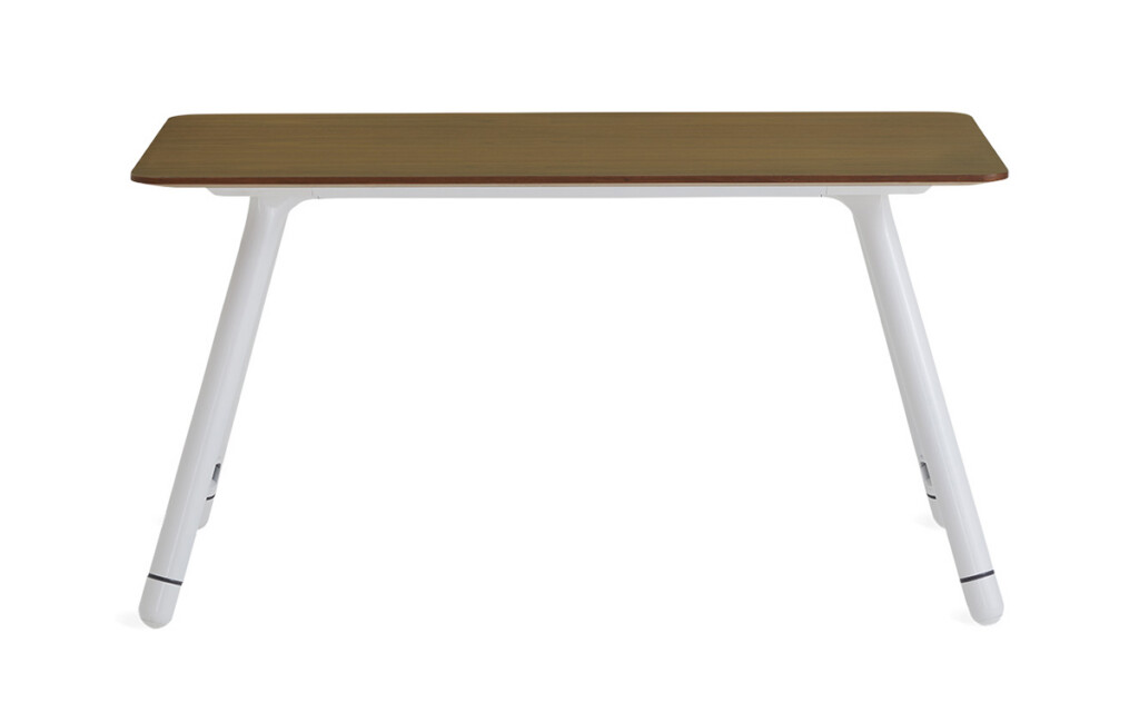 Wood table with white angled metal legs on neutral background