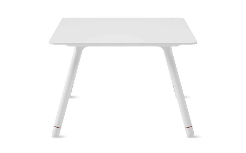 White table with white angled metal legs on neutral background