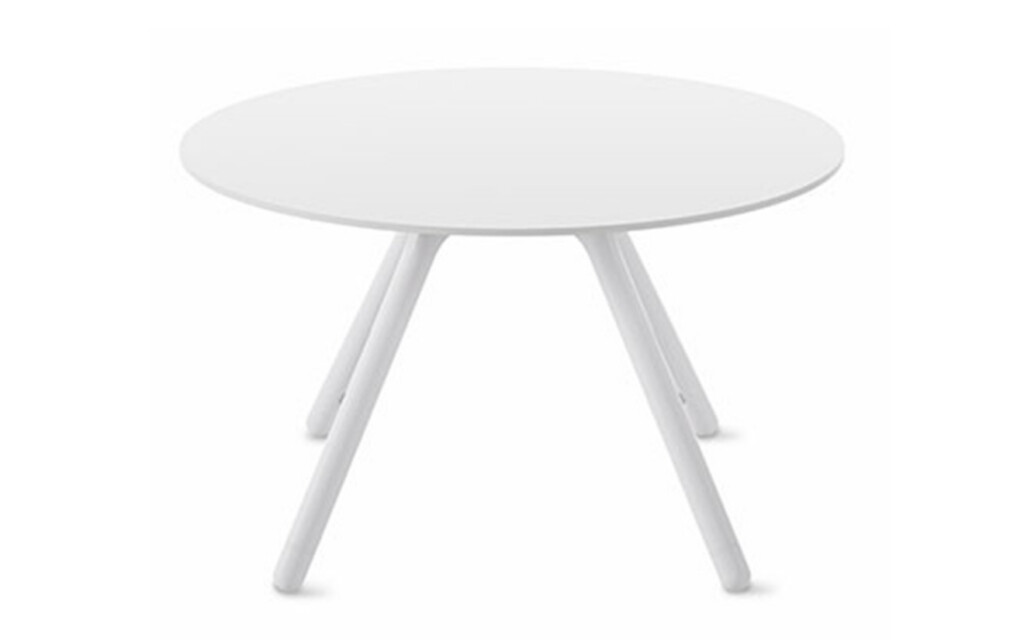 Round white table with white angled metal legs on neutral background