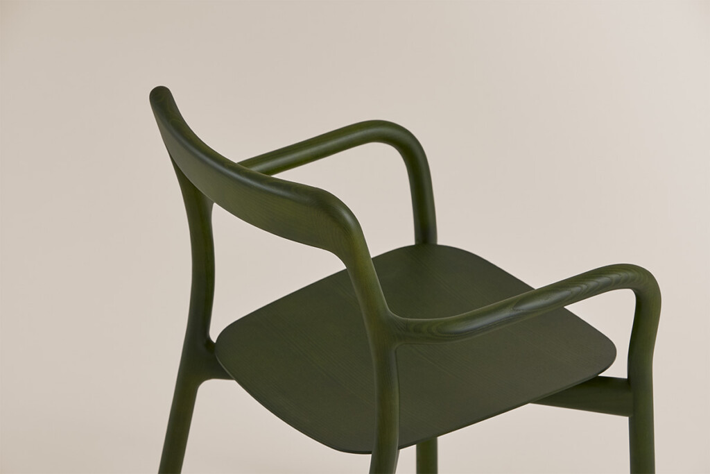 Close up green Branca chair on neutral background.