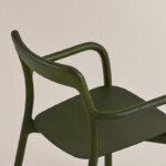 Close up green Branca chair on neutral background.