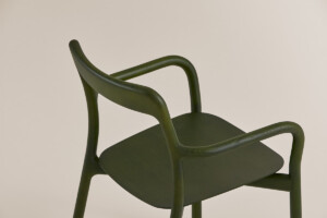 Close up green Branca chair on neutral background.