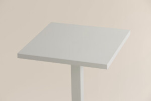 Close up view of white table on neutral background.