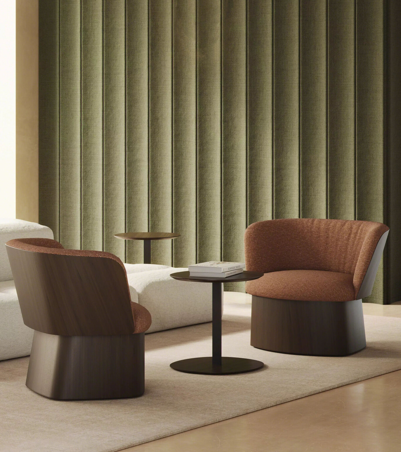 Seating arrangement with two lounge chairs and small tables set against a vertically textured green wall.