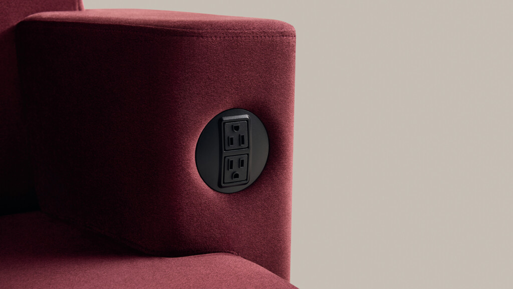 Close-up of modern upholstered lounge seating with integrated power outlet