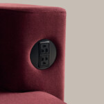 Close-up of modern upholstered lounge seating with integrated power outlet