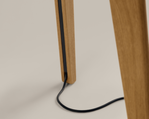 Close-up of wood table leg with cable management