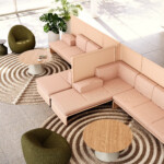 Modern lounge area with modular upholstered seating, round wood tables, and accent chairs