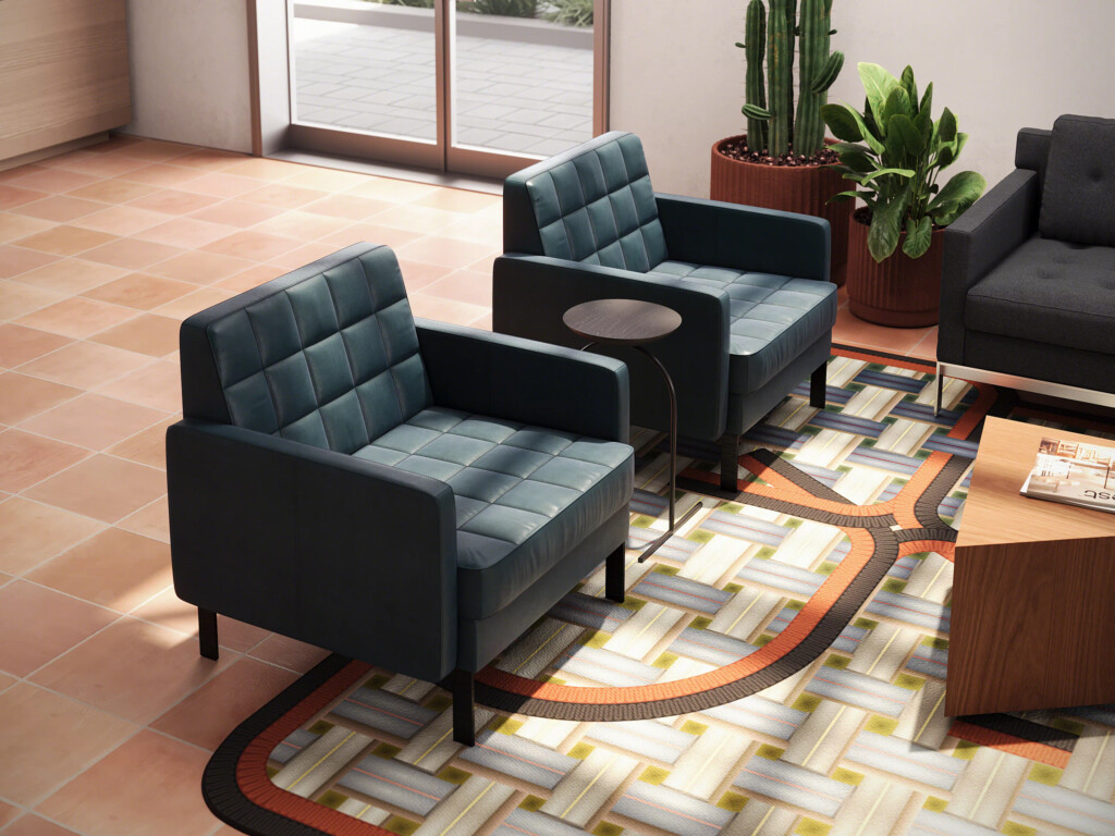 Modern lounge area with upholstered armchairs, side table, patterned rug, and wood coffee table