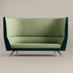 green high-back lounge sofa against neutral background