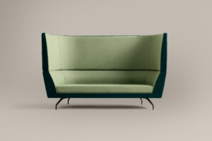 green high-back lounge sofa against neutral background