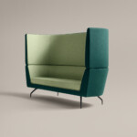 green high-back lounge sofa against neutral background