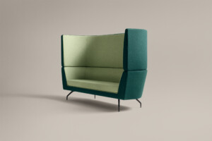 green high-back lounge sofa against neutral background