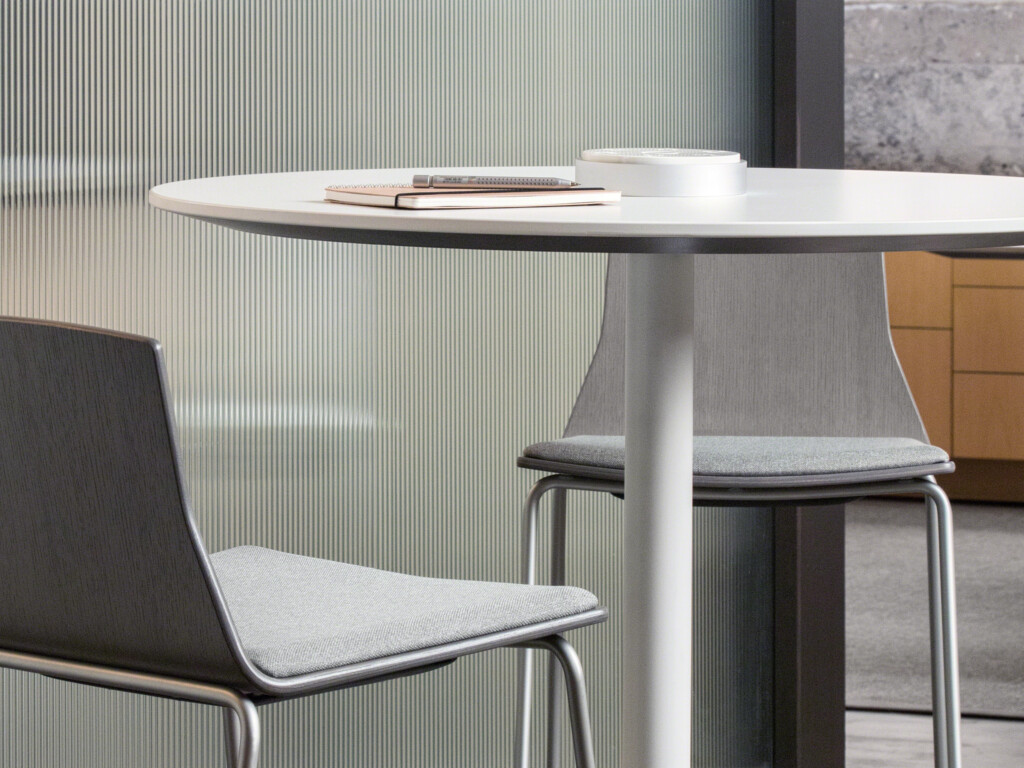 Two upholstered bar chairs with round table in the middle