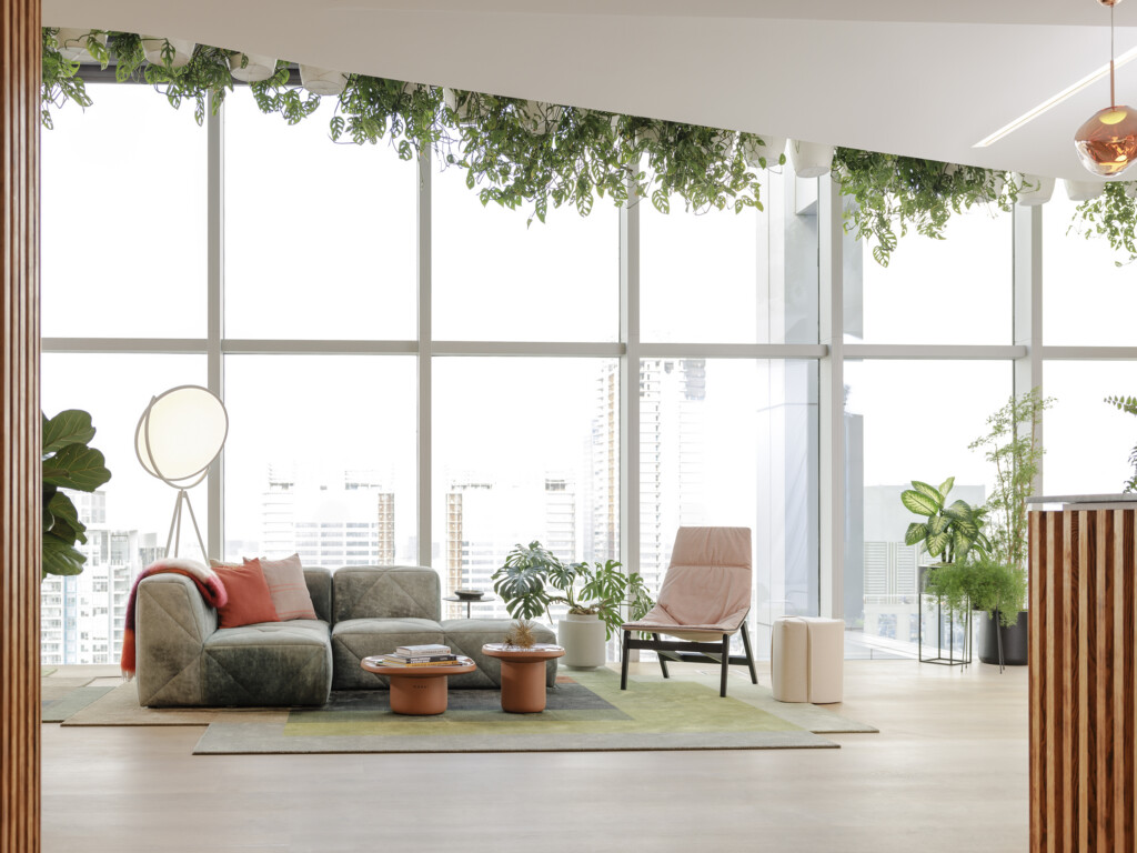 Modern lounge with an upholstered chair, a lounge sofa, and a landscape backdrop.