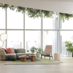 Modern lounge with an upholstered chair, a lounge sofa, and a landscape backdrop.