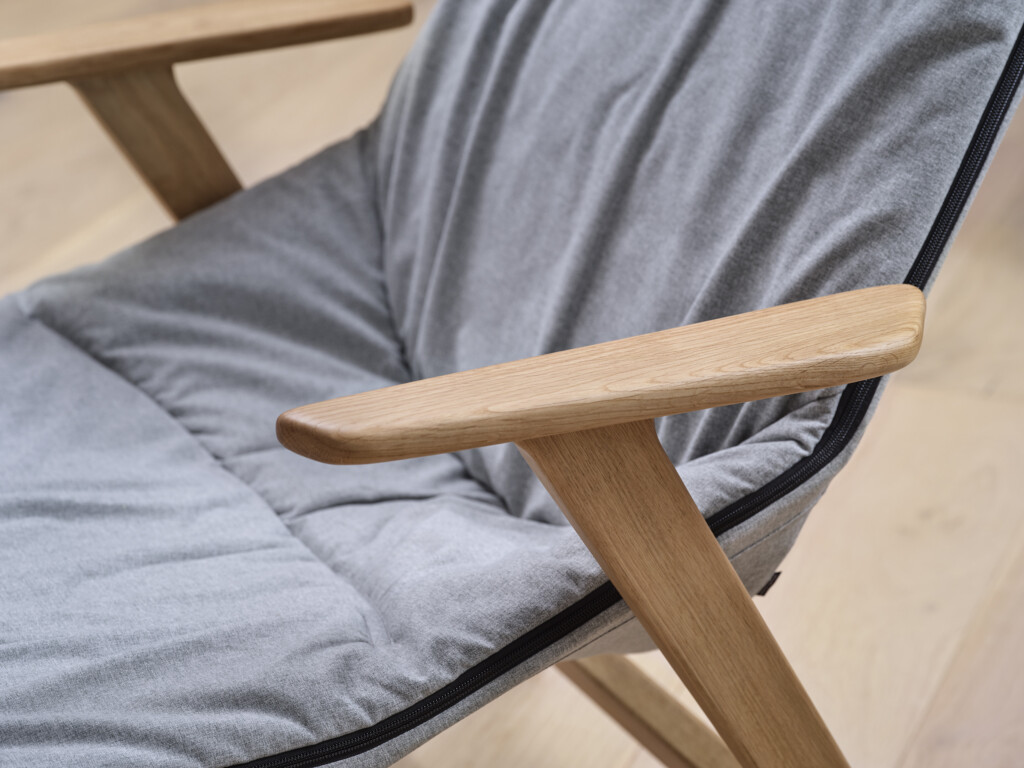 Close-up of gray chair with wooden legs