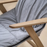 Close-up of gray chair with wooden legs