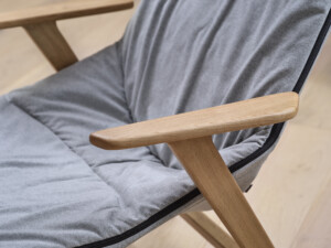 Close-up of gray chair with wooden legs