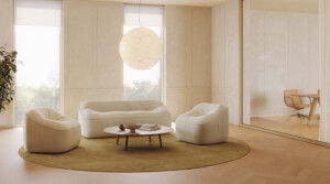 Modern lounge area with upholstered sofa, lounge chairs, round coffee table, and pendant lighting
