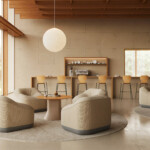 Modern lounge seating area with rounded armchairs and café bar