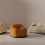 Modern upholstered lounge chair and sofa collection in soft neutral tones.