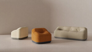 Modern upholstered lounge chair and sofa collection in soft neutral tones.