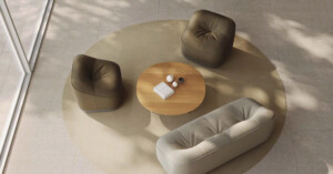 Modern seating group with upholstered lounge pieces and round coffee table.