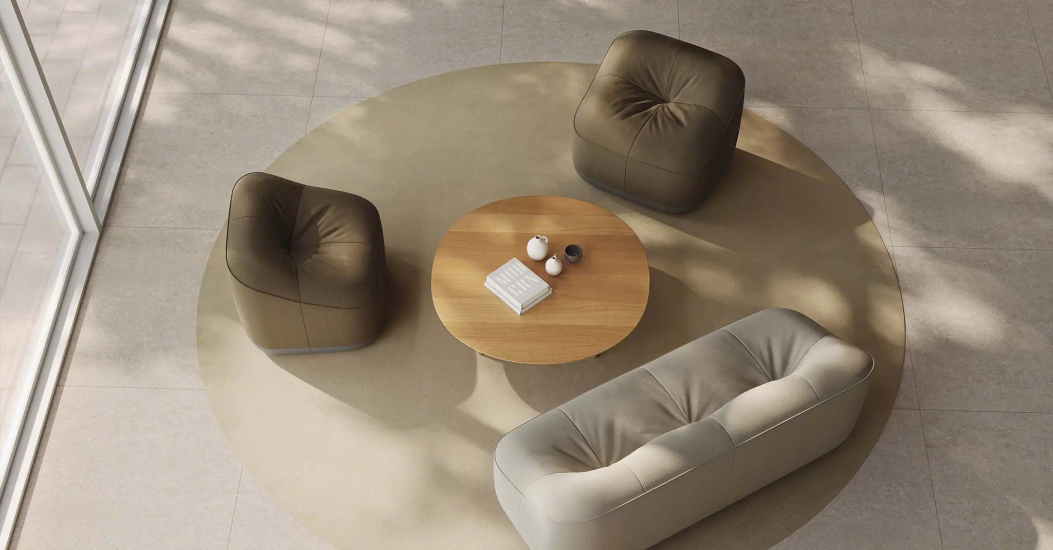Modern seating group with upholstered lounge pieces and round coffee table.